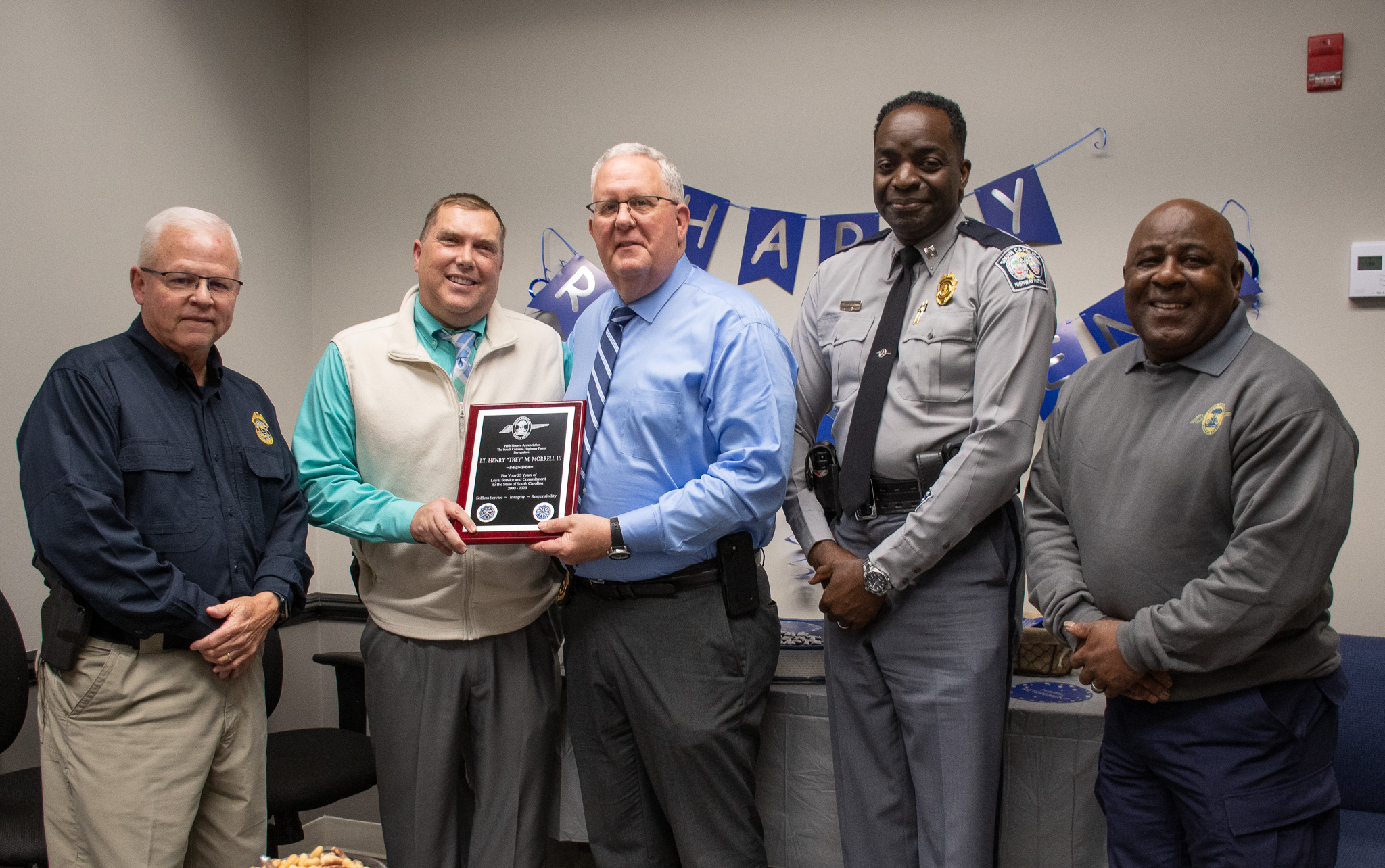 Lt Morrell with coworkers at retirement drop in