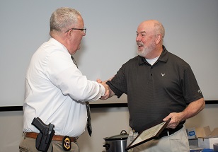 Bass shakes hands with Director Wood at the retirement party